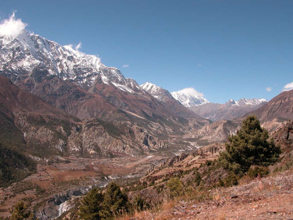 Annapurna 12 08 Looking Towards Manang From Ghyaru Looking up the valley toward Manang from Ghyaru, Annapurna III (7555m) had its head in the clouds. Just poking up behind Annapurna III was Gangapurna (7455m), and beyond Manang the Grande Barrire was in view. The airstrip at Hongde is visible in the lower centre.